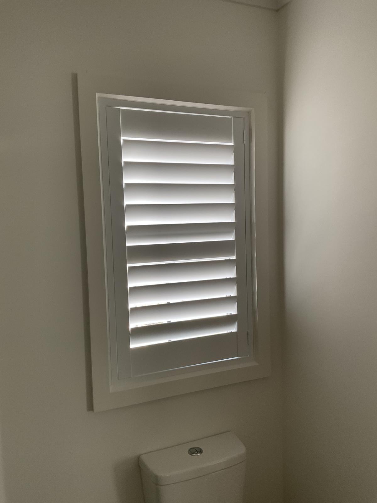Sheers paired with plantation shutters
