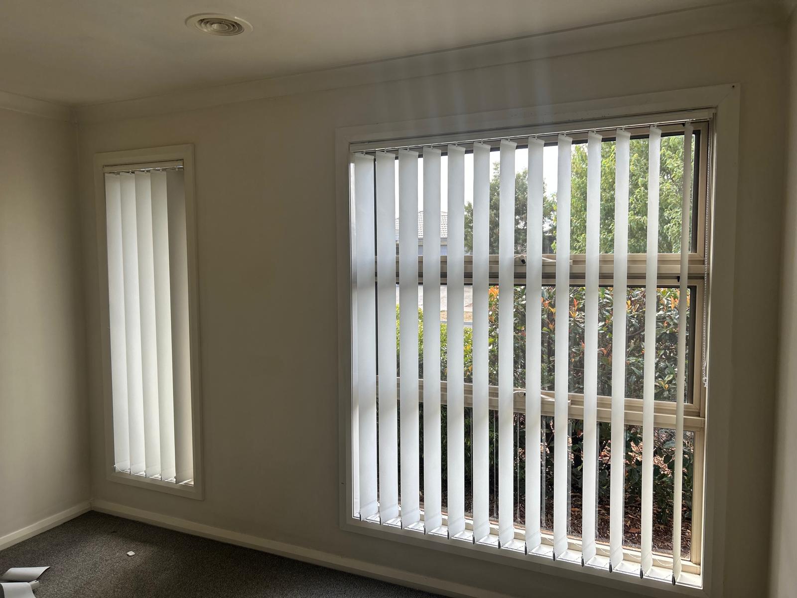 White Vertical Blinds across two windows