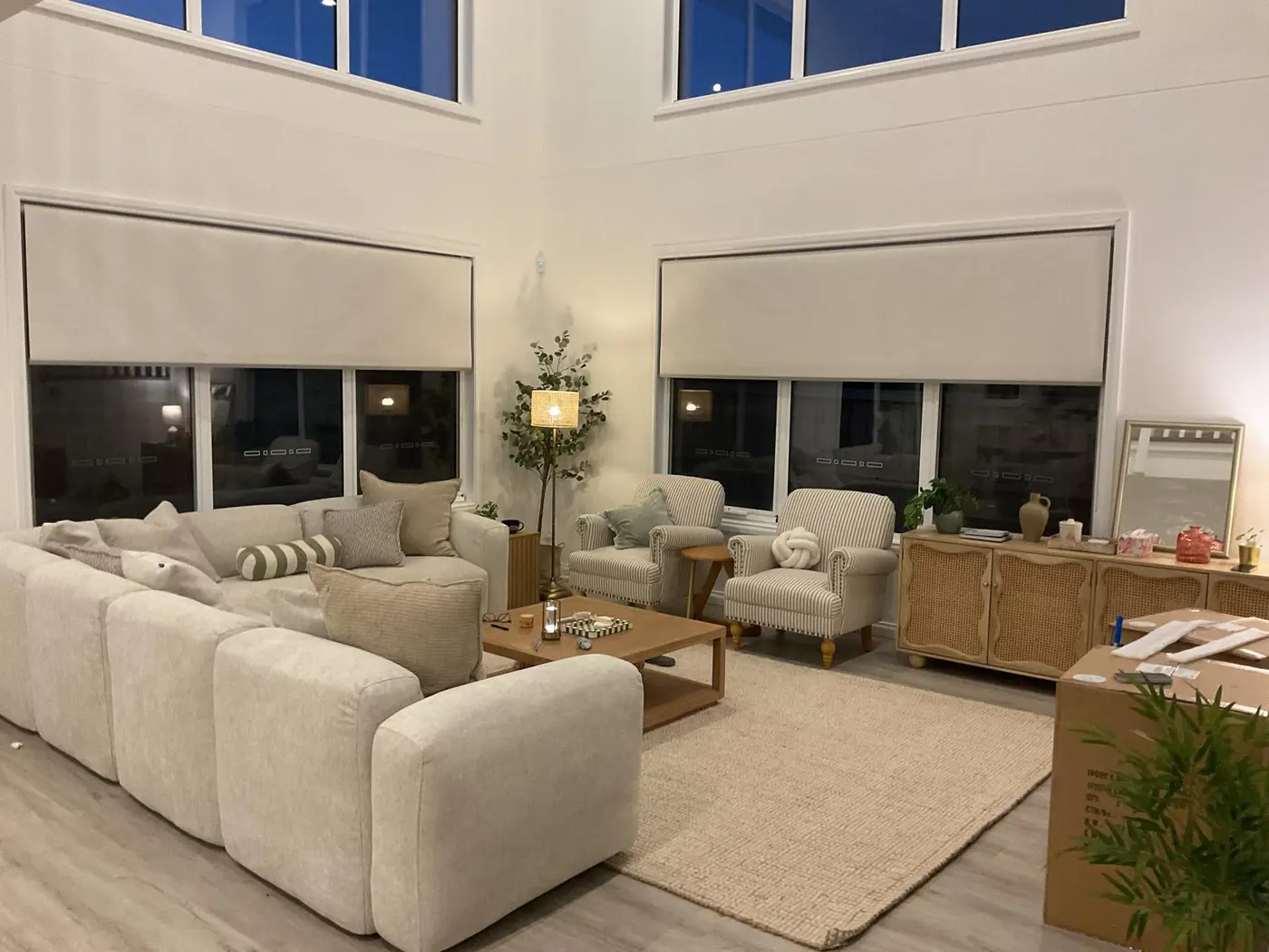 Custom blackout roller blinds in a double-height Melbourne living room