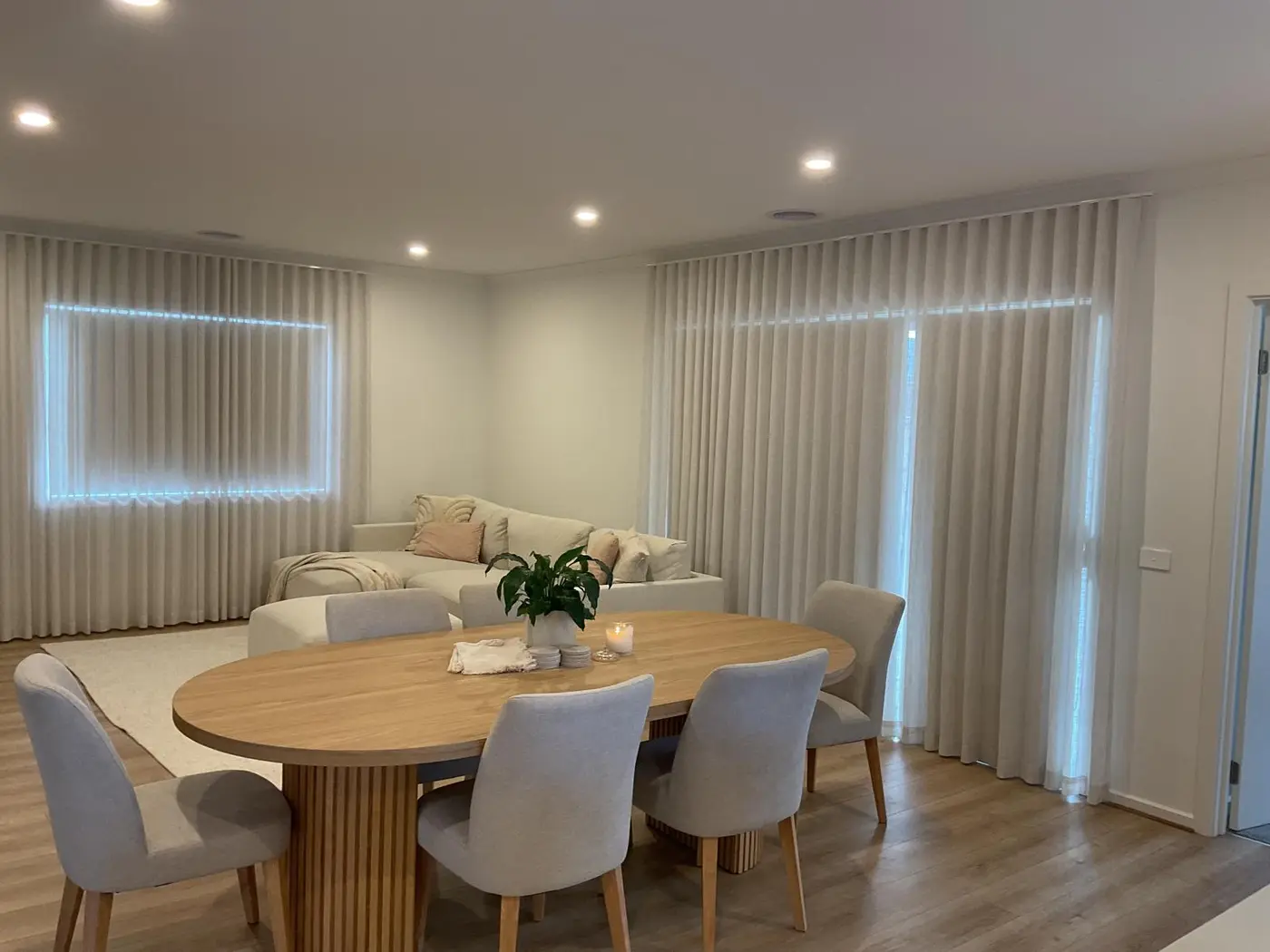 Floor-to-ceiling sheer curtains in a Melbourne living and dining room